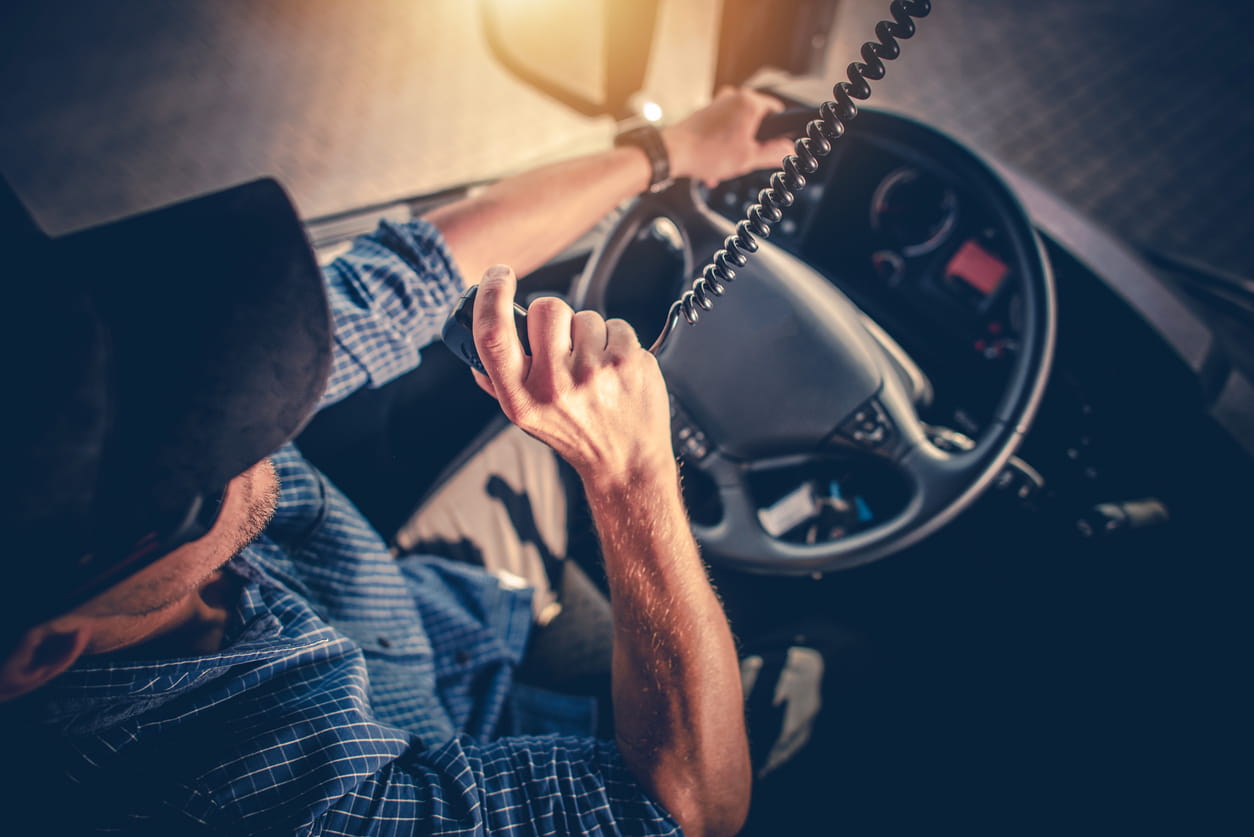 A truck driver talks on his CB radio while driving