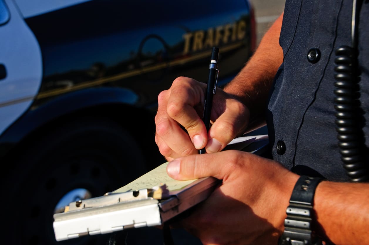 Police officer issuing a ticket after a car accident